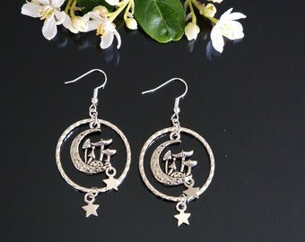 May include: Silver earrings with a crescent moon and mushroom design, accented with dangling stars.