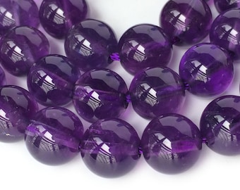 May include: A strand of round, purple amethyst beads. The beads are smooth and polished, with a high gloss finish.