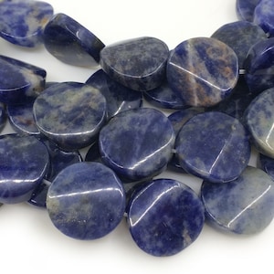 May include: A strand of blue and white gemstone beads. The beads are round and flat, with a smooth, polished finish.