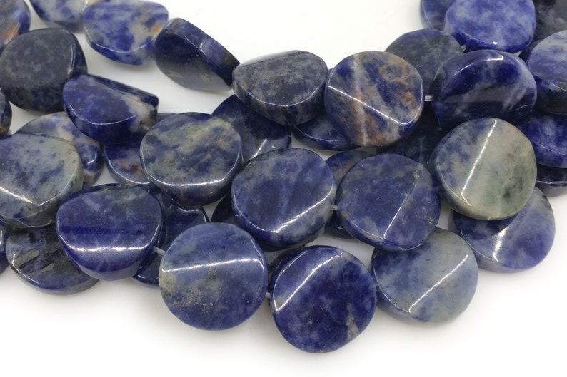 May include: A strand of blue and white gemstone beads. The beads are round and flat, with a smooth, polished finish.