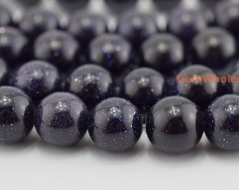 May include: A strand of dark blue gemstone beads with a speckled, starry appearance. The beads are round and smooth, and they are strung together on a clear thread.