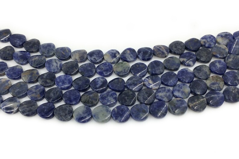 May include: A strand of blue and grey gemstone beads, each bead is a smooth, oval shape.
