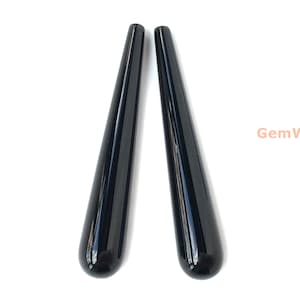 May include: Two black, polished, teardrop-shaped gemstone pendants.