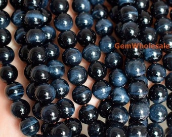 May include: A strand of dark blue tiger's eye beads. The beads are round and have a smooth, polished finish. The beads are approximately 8mm in diameter.