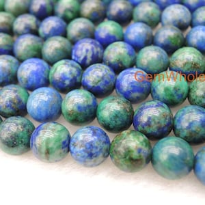May include: A strand of round, blue and green gemstone beads. The beads have a mottled, marbled appearance with flecks of gold.