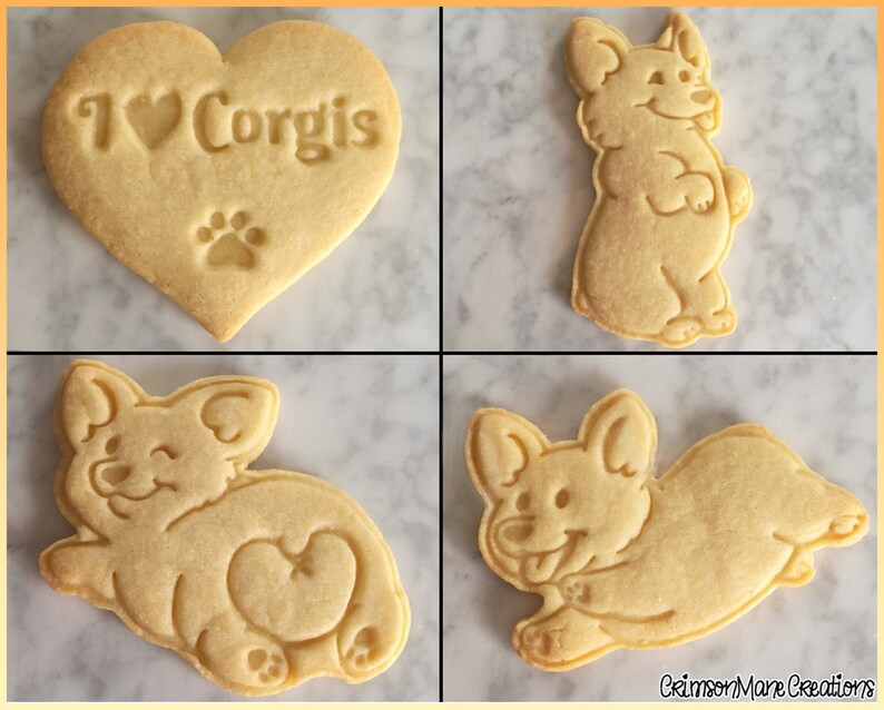 May include: Four light beige sugar cookies with embossed designs. One heart-shaped cookie reads I heart Corgis with a paw print. Three cookies feature different Corgi dog poses, including a standing dog, a lying dog, and a playful running dog.