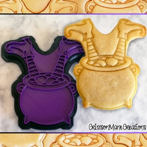 May include: Purple plastic cookie cutter shaped like a witch's legs sticking out of a cauldron. A baked cookie in the shape of the cutter is shown next to it.