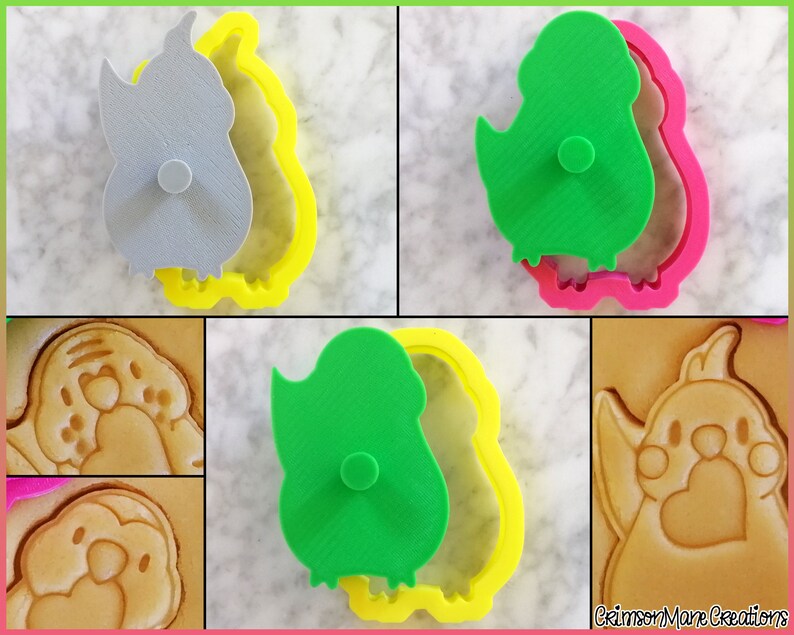 May include: A set of three cookie cutters in the shape of a cartoon bird. The cutters are made of plastic and are available in yellow, pink, and green. The cutters are shown with a cookie that has been cut out using the cutters.