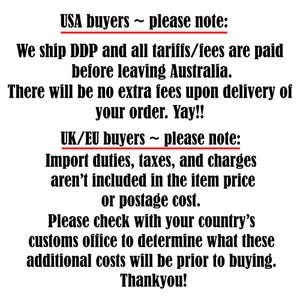 May include: Text on a white background, with the headings "USA buyers ~ please note:" and "UK/EU buyers ~ please note:". The text provides information about shipping and import duties.