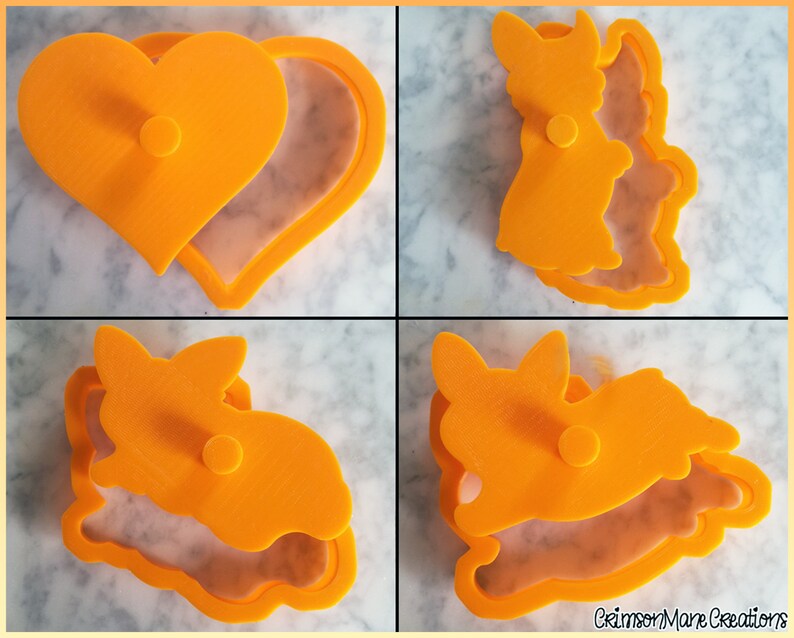 May include: A set of four bright orange plastic cookie cutters featuring a heart shape and three distinct rabbit silhouettes. Each cutter consists of a frame and a matching plunger top with a central handle for pressing dough into shapes.