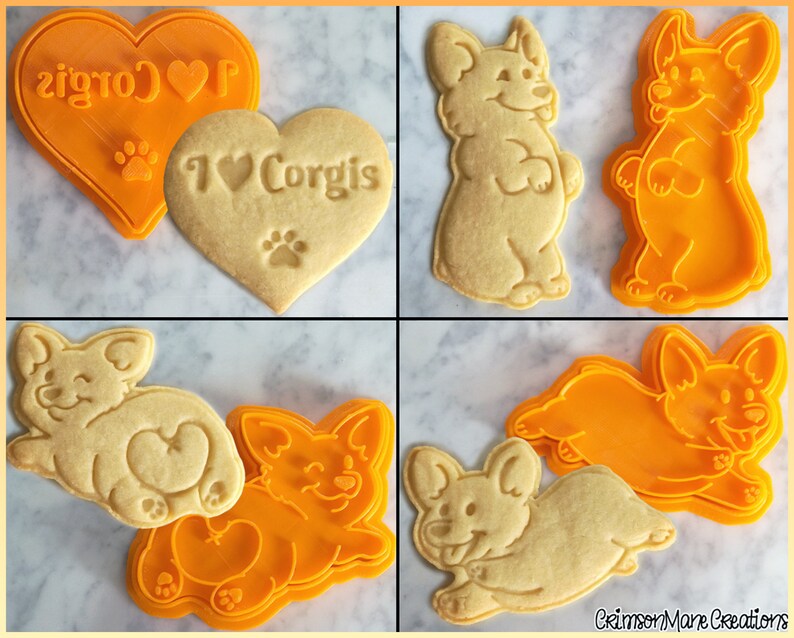 May include: A collection of orange plastic cookie cutters and corresponding baked cookies. The shapes include a heart with the text I Love Corgis and a paw print, a standing Corgi, a Corgi showing its rear, and a running Corgi with its tongue out.