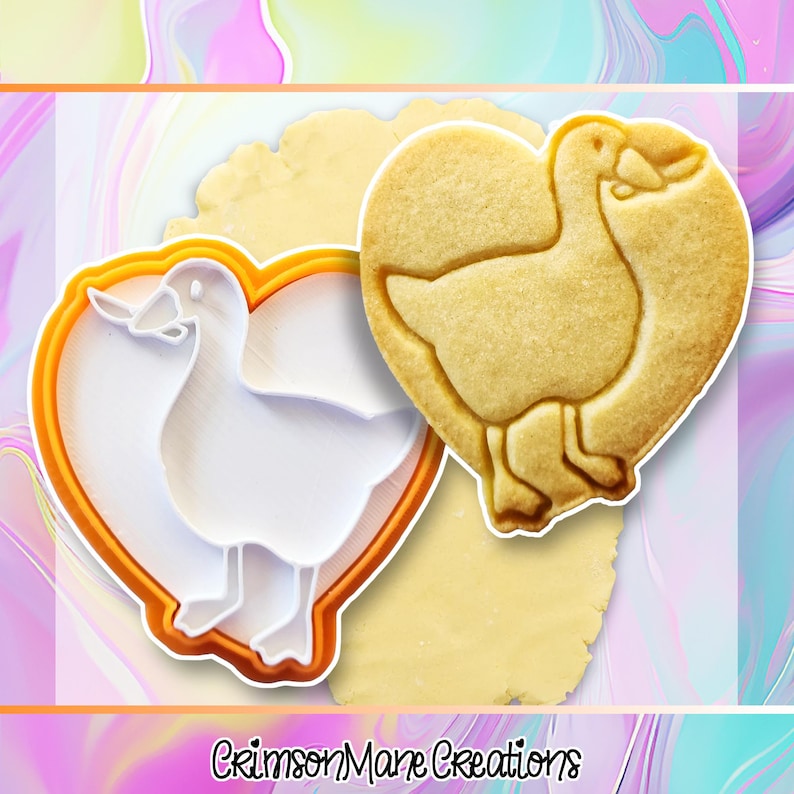 May include: A heart-shaped cookie cutter and a baked cookie, both featuring a goose design. The cookie cutter is white with an orange outline. The baked cookie is golden brown. The text "Crimson Mane Creations" is at the bottom.