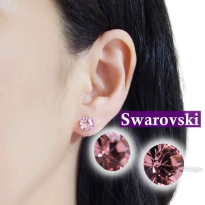 May include: A pair of pink crystal earrings with a silver backing. The earrings are made with Swarovski crystals. The text "Swarovski" is visible in the image.