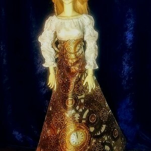 May include: A porcelain doll wearing a white blouse and a gold skirt with a steampunk design. The skirt features gears, cogs, and a clock face.
