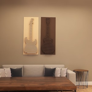 May include: Two wooden guitar wall art pieces, one light and one dark brown, hang above a gray sofa. The guitars are constructed from horizontal wooden slats. A wooden coffee table and a side table with a black metal base are in front of the sofa.