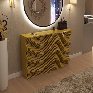 May include: A yellow console table with a wavy, geometric design. The table has a white top and is decorated with a vase of yellow flowers and a black purse.