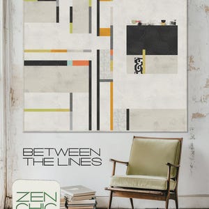 May include: A square quilt featuring a white background with geometric patterns in black, gray, orange, and lime green. The text "BETWEEN THE LINES" and "ZEN CHIC BRIGITTE HEITLAND" appears on the wall. A wooden chair with a light green cushion and a stack of books are positioned below the quilt.