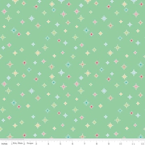 May include: A light green fabric with a repeating pattern of colorful starbursts. The starbursts are outlined in white and filled with pastel colors like pink, yellow, and blue. The fabric is measured in inches.