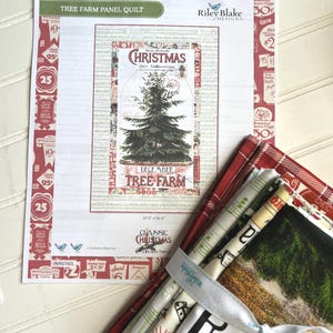 May include: A quilt pattern titled "Tree Farm Panel Quilt" with a Christmas tree design, accompanied by a bundle of fabric squares tied with a ribbon. The pattern measures 37.5 x 56.8 inches.