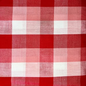 May include: A fabric textile featuring a classic red and white gingham check pattern. The design consists of alternating solid red squares and white squares, with a lighter pinkish-red hue appearing where the colors overlap in the weave.