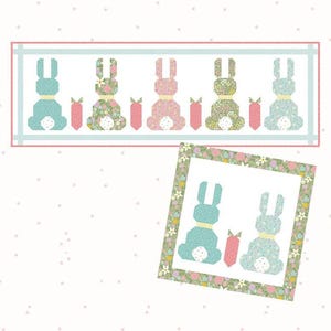 May include: A pattern for a Sweet Spring Bunny runner and pillow. The design features bunny and carrot shapes in pastel colors. The runner size is 18" x 55", and the pillow size is 22" x 22". The Flamingo Toes logo is also visible.