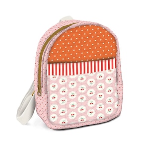May include: A quilted backpack featuring a pink base with a red polka dot pattern, an orange upper section with white dots, a red and white striped horizontal band, and a lower section decorated with a repeating pattern of small red cherries.