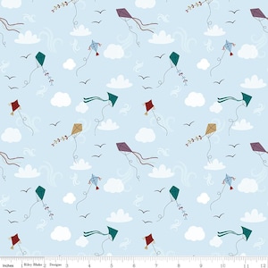 May include: A light blue fabric with a repeating pattern of colorful kites, white clouds, and black birds. The kites are various colors, including red, green, purple, and gold. The design is whimsical and suitable for children's projects.