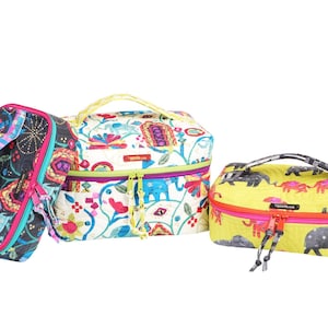 May include: Three colorful cosmetic bags with various patterns. One bag is black with a floral and geometric design, another is white with a floral and elephant design, and the third is yellow with elephant silhouettes.