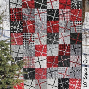 May include: A patchwork quilt with the name "Emma" in large white letters. The quilt features a grid of squares in red, black, white, and gray patterns. The quilt measures 48" x 56" and is labeled as a 10" square quilt.
