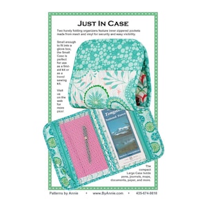May include: A teal and white floral patterned organizer, open to display a pink mesh pocket and a brochure. The text "JUST IN CASE" is at the top, with additional text describing the product's features and uses. The organizer is designed for travel and storage.