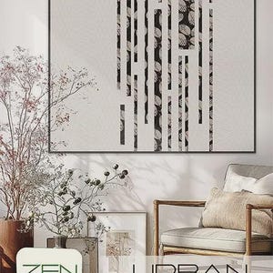 May include: Abstract wall art with a black frame. The artwork features a white background with vertical black and patterned stripes. The image also includes a chair, plants, and the text "ZEN CHIC" and "URBAN GRID".
