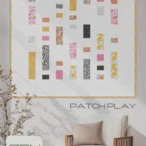 May include: A framed quilt with a white background and a patchwork design. The quilt features rectangular blocks in various colors and patterns, including pink, yellow, black, and orange. The text "PATCH PLAY" is below the quilt.
