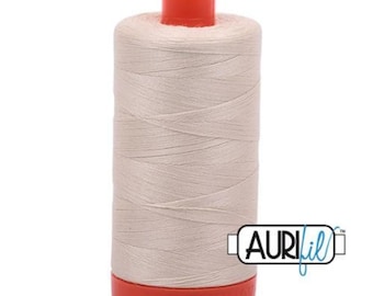 May include: A spool of off-white sewing thread with a red top and base. The thread is tightly wound, and the spool has the Aurifil logo on the side. This thread is likely used for quilting, embroidery, or general sewing projects.