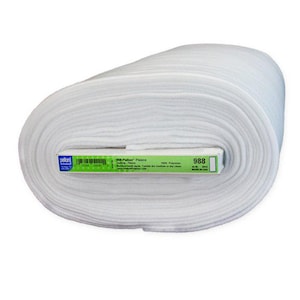 May include: A white roll of Pellon 988 Fleece Quilting Fabric. The label reads "988 Pellon Fleece Quilting Fleece 100% Polyester Machine Wash Warm Tumble Dry Low Heat or Dry Clean Made in USA 988"