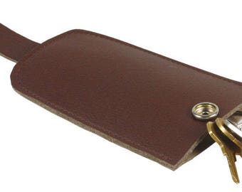 May include: A brown leather key holder with a snap closure and a loop for attaching to a belt or bag. The holder is open and several keys are sticking out.