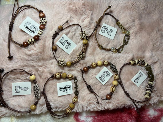 Bohemian bracelets made with waxed threads wood beads and metal connectors. 7 items Sell separately All adjust up to 10 inches.
