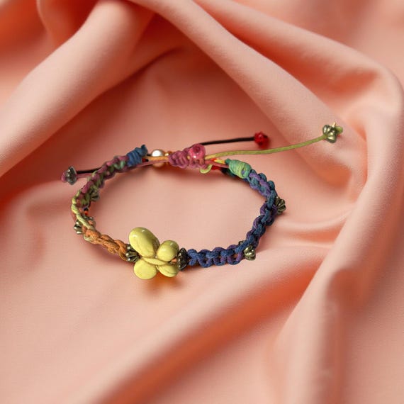 Macrame bracelet with ceramic pink Butterfly in woven square knot style. Adjustable upto 10 inches.
