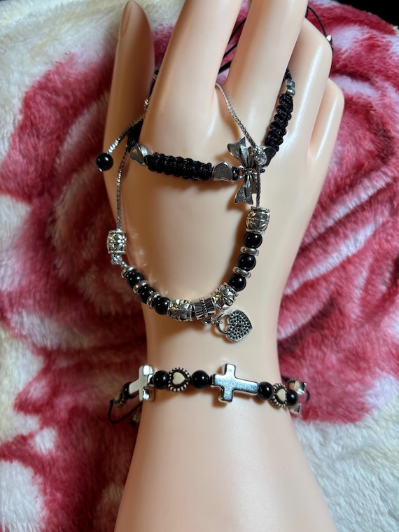 Three Braided bracelets selling separately. Made of nylon thread, silver beads, metal cross and wood hearts. adjust up to 10 inches.
