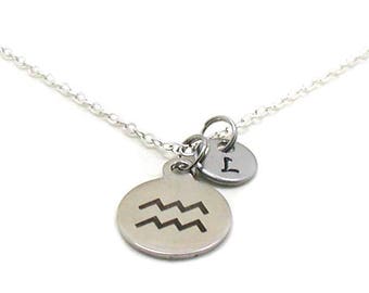 May include: Silver necklace with two charms. One charm is a circle with the astrological symbol for Aquarius. The other charm is a circle with the number 1.