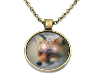 May include: A bronze chain necklace with a round pendant featuring a close-up image of a fox's face.