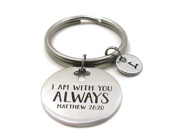 May include: Silver keychain with a round charm that says "I am with you always Matthew 28:20".