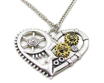 May include: A silver necklace with a heart-shaped pendant featuring a steampunk design. The pendant is made of metal gears and cogs, with some gold accents.