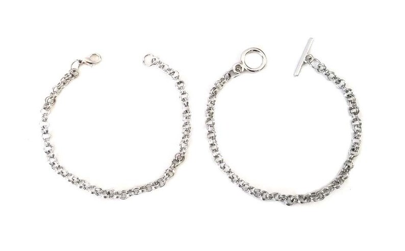 May include: Two silver chain bracelets, one with a t-bar clasp and the other with a lobster claw clasp.