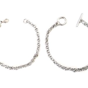 May include: Two silver chain bracelets, one with a t-bar clasp and the other with a lobster claw clasp.
