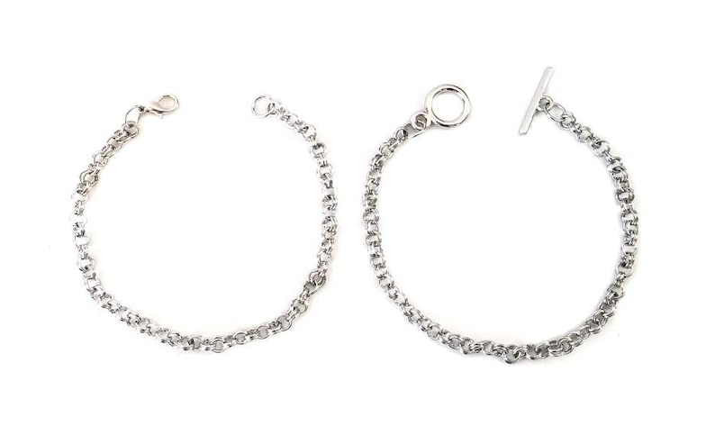 May include: Two silver chain bracelets, one with a t-bar clasp and the other with a lobster claw clasp.