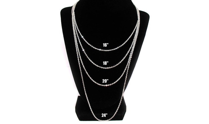 May include: Four silver chains of different lengths displayed on a black mannequin. The chains are 16 inches, 18 inches, 20 inches, and 24 inches long.