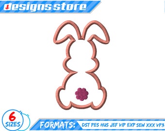 May include: A pink bunny rabbit embroidery design with a pink flower on its bottom. The design is outlined in brown.