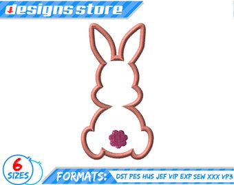 May include: A pink outline of a bunny rabbit with a pink flower on its bottom. The bunny is sitting upright with its ears up.
