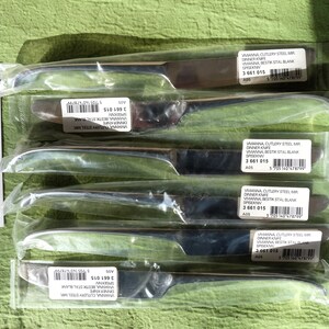 May include: Five individually packaged stainless steel dinner knives. Each knife is labeled "VIVANNA CUTLERY STEEL MIR" and "DINNER KNIFE".