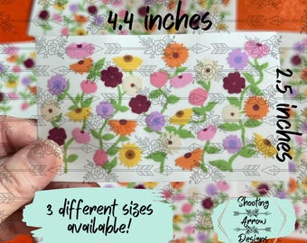 May include: A rectangular sticker sheet featuring a floral pattern with orange, yellow, pink, purple, and maroon flowers on green stems. The text 4.4 inches and 2.5 inches is printed on the sheet, along with 3 different sizes available! and Shooting Arrow Designs.